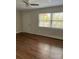 Neutral living room featuring wood-look floors, a ceiling fan and a side entrance at 2921 Fort St, Charlotte, NC 28205