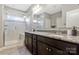 Bathroom featuring double sinks with granite countertops and a separate glass shower at 2934 Hiddenbrook Way, Fort Mill, SC 29707