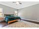 Primary bedroom featuring a ceiling fan, tray ceiling, and two windows for plenty of light at 2934 Hiddenbrook Way, Fort Mill, SC 29707