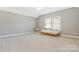 Bright bedroom featuring neutral walls, carpet, a window, and a ceiling fan at 2934 Hiddenbrook Way, Fort Mill, SC 29707