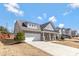 Beautiful home with a long driveway, two-car garage, and a covered front porch in a residential neighborhood at 2934 Hiddenbrook Way, Fort Mill, SC 29707