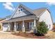 Charming home featuring stone accents, wood-like siding, and a welcoming front porch with decorative landscaping at 2934 Hiddenbrook Way, Fort Mill, SC 29707