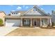 Charming brick home featuring a covered front porch, two-car garage and beautiful architectural details at 2934 Hiddenbrook Way, Fort Mill, SC 29707