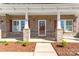 Charming covered front porch with stone accents, wood-like siding, and decorative shutters at 2934 Hiddenbrook Way, Fort Mill, SC 29707