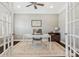 Bright home office featuring glass doors, a ceiling fan, and a neutral color scheme at 2934 Hiddenbrook Way, Fort Mill, SC 29707