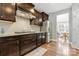 A modern kitchen with dark wood cabinetry, granite countertops, and stainless steel appliances at 2934 Hiddenbrook Way, Fort Mill, SC 29707