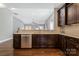 Modern kitchen with stainless steel appliances and granite countertops overlooking large living room at 2934 Hiddenbrook Way, Fort Mill, SC 29707