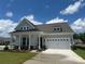 Inviting single-story home with a two-car garage, manicured lawn and covered front porch at 305 Basil Dr, Indian Trail, NC 28079