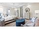 This primary bedroom features a seating area, dresser, and modern chandelier at 305 Basil Dr, Indian Trail, NC 28079