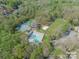 Aerial view of community amenities including pool, tennis courts, and volleyball court nestled among trees at 3200 Highview Rd, Charlotte, NC 28210
