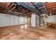 Unfinished basement with concrete floor, exposed ceiling, utilities, and garage access at 3200 Highview Rd, Charlotte, NC 28210
