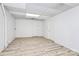 Spacious basement with finished walls, wood-look vinyl flooring, and two interior doors at 3200 Highview Rd, Charlotte, NC 28210