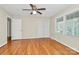 Bedroom featuring wood floors, closet, and a large window providing ample natural light at 3200 Highview Rd, Charlotte, NC 28210