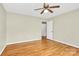 Bedroom with hardwood floors, ceiling fan, and adjoining doorway at 3200 Highview Rd, Charlotte, NC 28210
