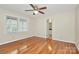 Bright bedroom featuring a ceiling fan, wood floors, and natural light from the large window at 3200 Highview Rd, Charlotte, NC 28210
