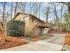 Brick home featuring a deck, a lower level garage, and mature landscaping at 3200 Highview Rd, Charlotte, NC 28210