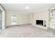 Bright living room with a white brick fireplace and built-in shelving and hardwood floors in the hallway at 3200 Highview Rd, Charlotte, NC 28210