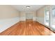 Spacious living room with hardwood floors, wainscoting, and bright natural light at 3200 Highview Rd, Charlotte, NC 28210