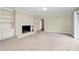 Cozy living room featuring a brick fireplace and built-in shelving at 3200 Highview Rd, Charlotte, NC 28210