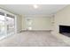 Spacious living room featuring a brick fireplace, built-in shelving, and access to the deck at 3200 Highview Rd, Charlotte, NC 28210