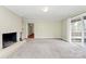 Comfortable living room featuring a painted brick fireplace and sliding doors to the deck at 3200 Highview Rd, Charlotte, NC 28210