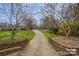 Community walkway surrounded by greenery and trees at 3200 Highview Rd, Charlotte, NC 28210
