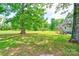 Expansive backyard featuring a charming two-story home with a wooden staircase and lush greenery at 3640 Oak Haven Ln, Shelby, NC 28150
