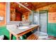 Bathroom featuring wood paneling, a double vanity with granite countertop, and glass enclosed shower at 3640 Oak Haven Ln, Shelby, NC 28150