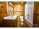 Full bathroom showcasing wood walls, vanity, toilet and tub/shower combination at 3640 Oak Haven Ln, Shelby, NC 28150