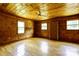 Bedroom with natural lighting, ceiling fan, wood walls, and hardwood floors at 3640 Oak Haven Ln, Shelby, NC 28150