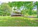 Charming home with covered porch surrounded by lush greenery and mature trees at 3640 Oak Haven Ln, Shelby, NC 28150