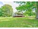 Charming home with covered porch surrounded by lush greenery and mature trees at 3640 Oak Haven Ln, Shelby, NC 28150