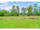View of garden boxes surrounded by lush greenery, under a sunny, partly cloudy sky at 3640 Oak Haven Ln, Shelby, NC 28150