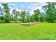 Lush yard featuring garden boxes with a solar panel system in the background on a sunny day at 3640 Oak Haven Ln, Shelby, NC 28150