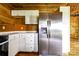 Modern kitchen with white cabinets, marble countertops, and stainless steel refrigerator at 3640 Oak Haven Ln, Shelby, NC 28150