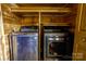 Convenient laundry room with modern washer and dryer, and wood shelving for storage at 3640 Oak Haven Ln, Shelby, NC 28150