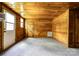 Cozy living room with knotty pine wood walls, carpet floors, and abundant natural light at 3640 Oak Haven Ln, Shelby, NC 28150