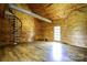 Spacious living room featuring wood walls, wood floors, spiral stairs and natural light at 3640 Oak Haven Ln, Shelby, NC 28150