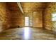 Sunlit living area with hardwood floors, wood walls and an exterior door for easy access at 3640 Oak Haven Ln, Shelby, NC 28150