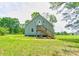 Charming home featuring a backyard entrance with wooden stairs and a spacious, green lawn at 3640 Oak Haven Ln, Shelby, NC 28150