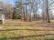 Spacious backyard featuring mature trees, offering plenty of room for outdoor activities and landscaping opportunities at 3711 Davis Dr, Charlotte, NC 28270