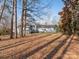 Rear view of the home showcasing its large backyard with mature trees providing shade and privacy at 3711 Davis Dr, Charlotte, NC 28270