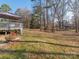 Expansive backyard featuring a deck, fire pit and mature trees, perfect for outdoor activities and entertaining at 3711 Davis Dr, Charlotte, NC 28270