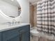 Modern bathroom featuring a round mirror with integrated lighting, stylish vanity, and bathtub with shower at 3711 Davis Dr, Charlotte, NC 28270
