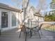 A deck with an outdoor dining table and chairs, perfect for enjoying outdoor meals and gatherings at 3711 Davis Dr, Charlotte, NC 28270