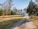 Attractive light-blue one-story home with an attached garage and a spacious driveway at 3711 Davis Dr, Charlotte, NC 28270