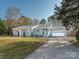Inviting single-story house with a light-blue facade, white trim, attached garage, and a paved driveway at 3711 Davis Dr, Charlotte, NC 28270