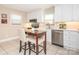 Bright kitchen featuring white cabinetry, stainless steel appliances, and a cozy breakfast nook at 3711 Davis Dr, Charlotte, NC 28270