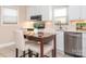 Bright kitchen featuring white cabinetry, stainless steel appliances, and a cozy breakfast nook at 3711 Davis Dr, Charlotte, NC 28270