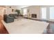 Bright living room featuring hardwood floors, a stone fireplace, and ample space for entertaining guests at 3711 Davis Dr, Charlotte, NC 28270